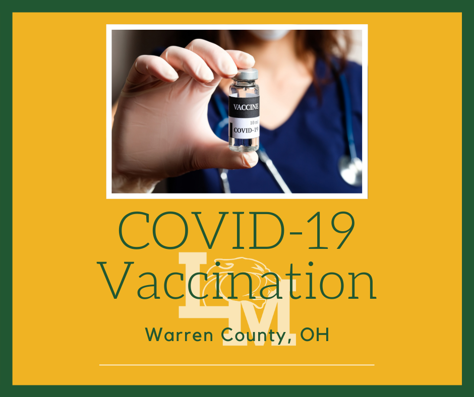 nurse holding a vial of COVID vaccine